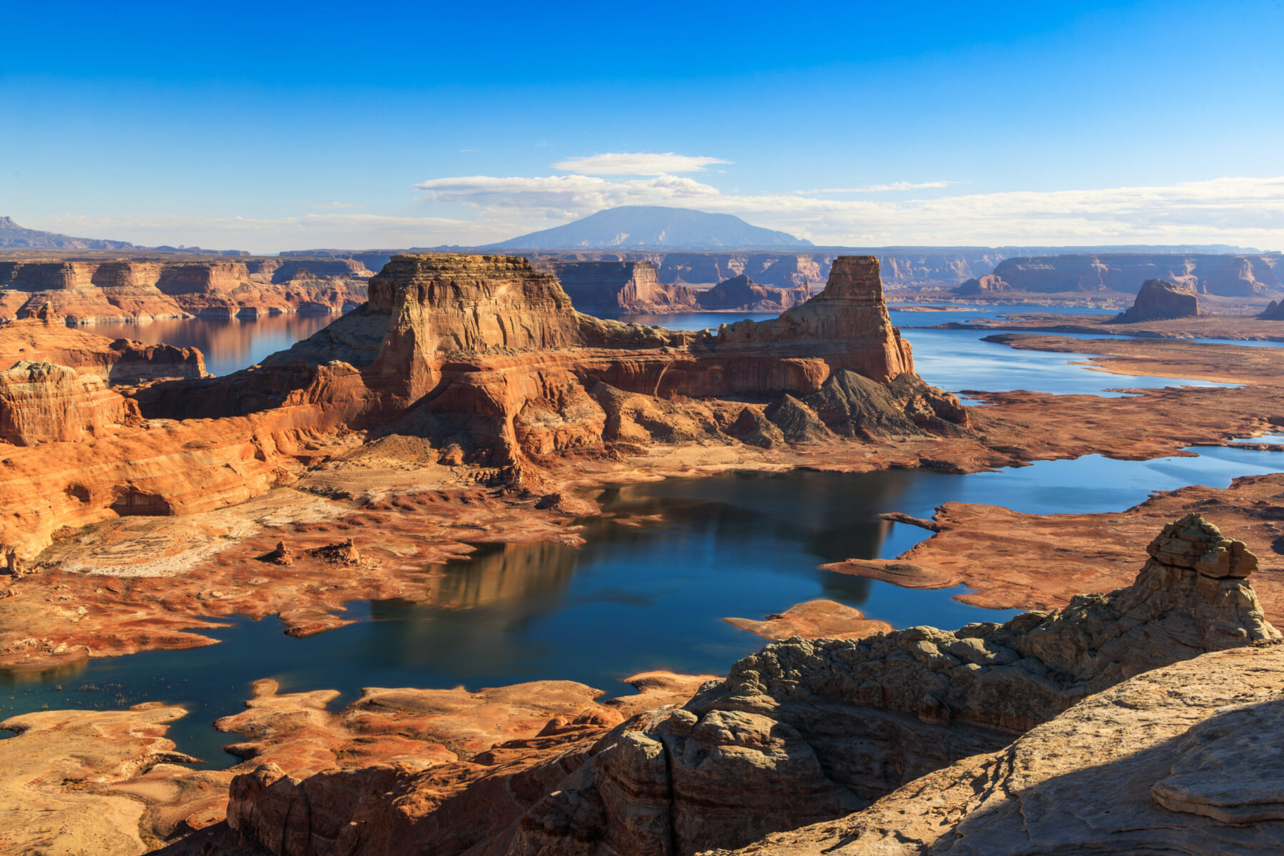 Alstrom Point overlook above Lake Powell with sandstone mesas, deep blue water, and distant desert mountains in southern Utah.