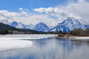 Snow-covered Teton mountains reflected in calm water at Oxbow Bend, Grand Teton National Park landscape photography