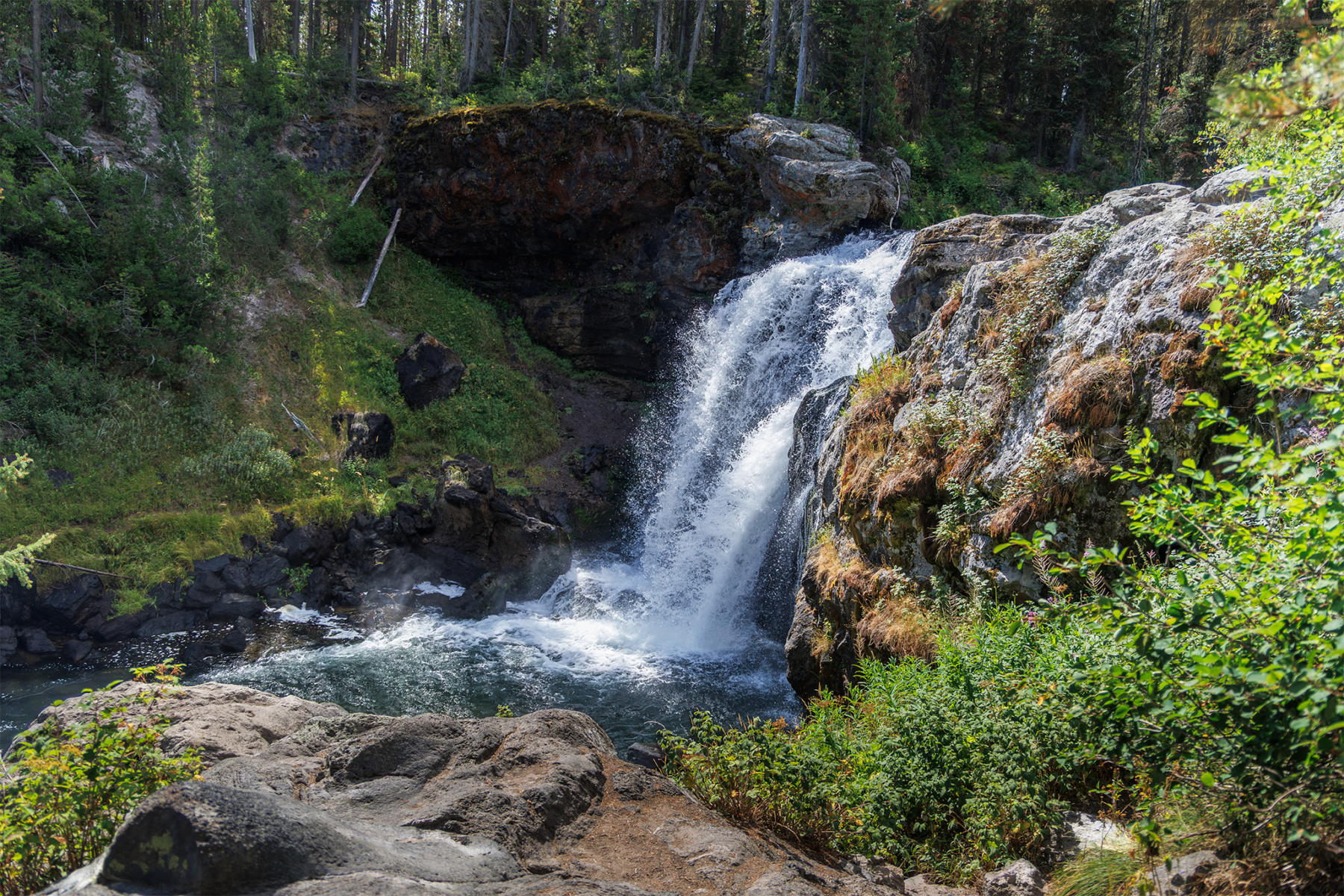 Moose Falls waterfall cascading over rocky ledge into pool, Yellowstone National Park landscape photography