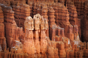 Close-up view of red rock hoodoos in Bryce Canyon National Park, Utah, with towering spires and natural formations carved by erosion.